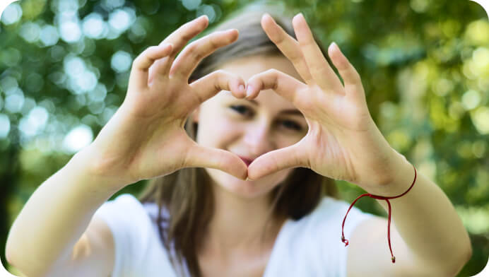 Girl shows heart by hands